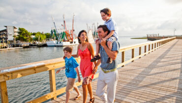 Family walking on the pier